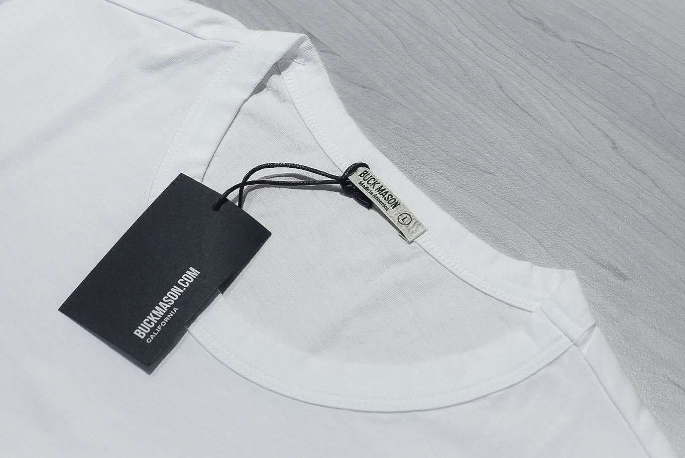 Buck Mason white tee collar and label close up