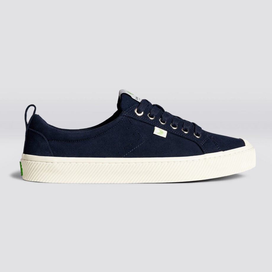 Stylish blue sneakers with green logo detail.