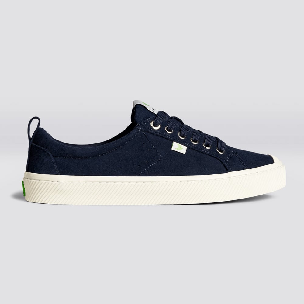 Stylish blue sneakers with green logo detail.