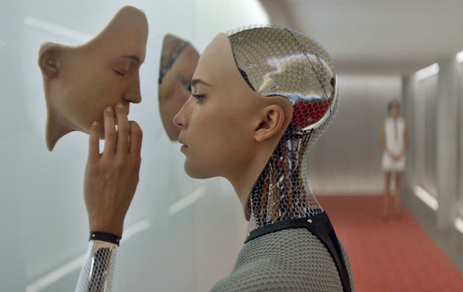 Robot examines face mask; observer stands in eerie hallway.