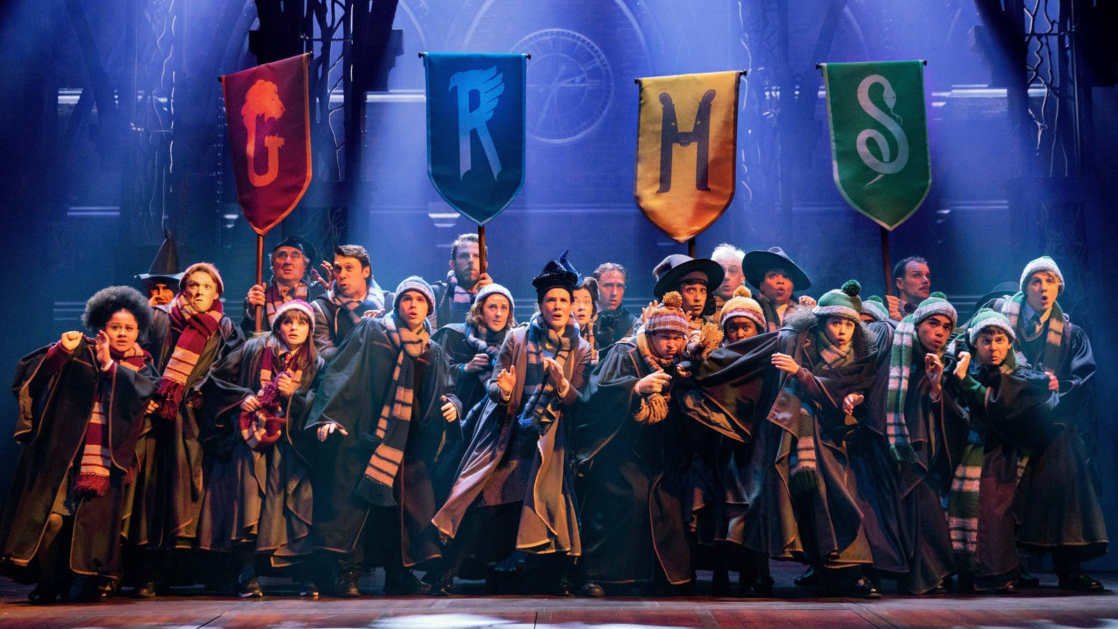 Group in robes resembles "Cursed Child" performance.