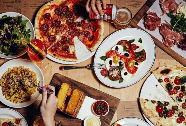 Melbourne feast: pizza, pasta, salad, drinks await.