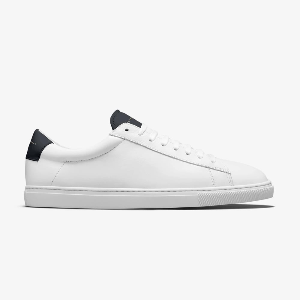 Minimalist white sneakers with black accents.