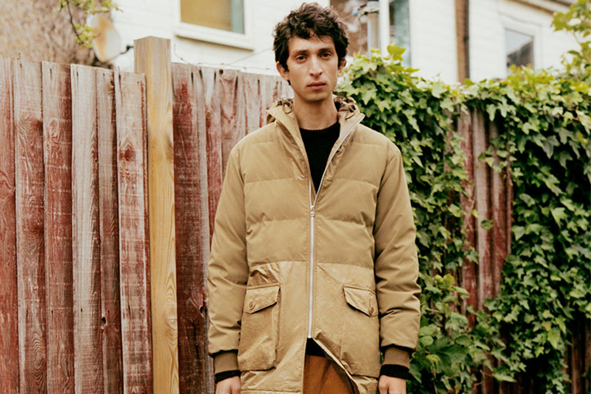 Person models tan parka; ready for Black Friday.