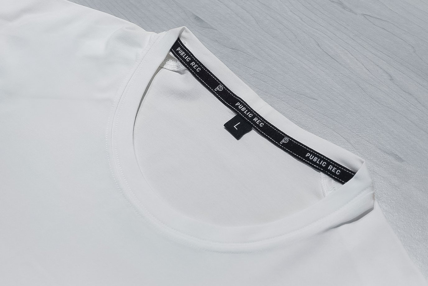 Public Rec white tee collar and label close up