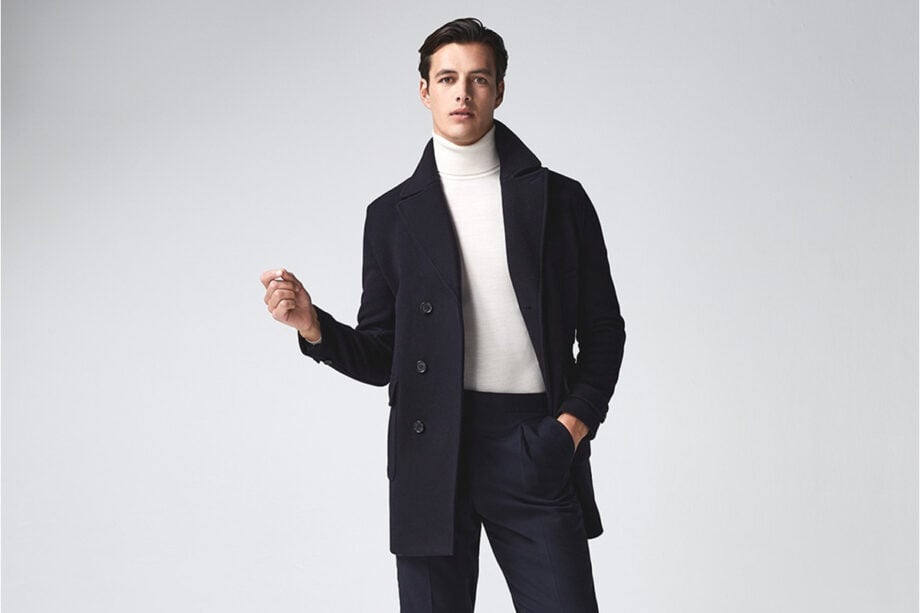Person models stylish coat and turtleneck ensemble.