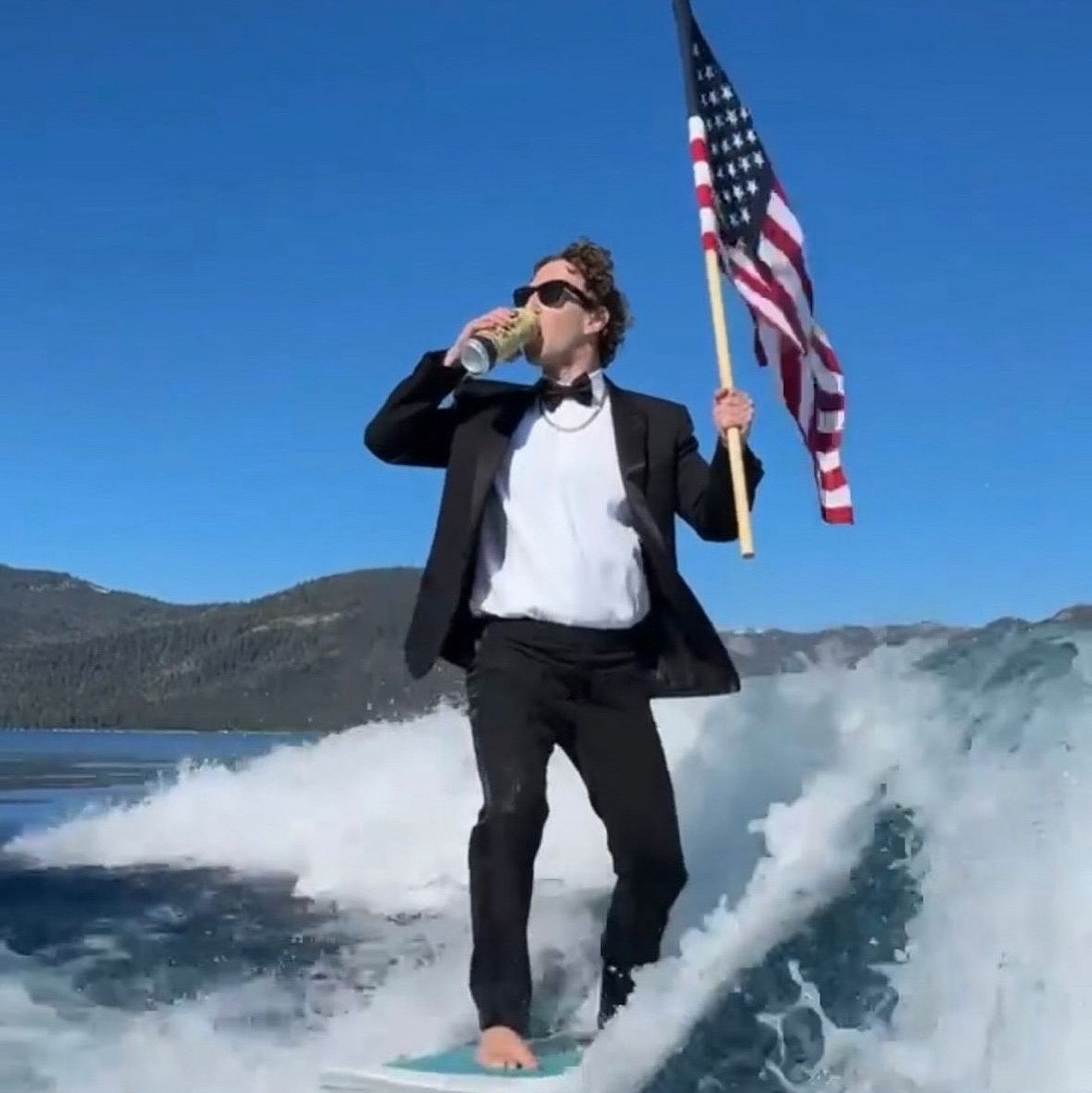 Mark Zuckerberg surfing and drinking beer with american flag